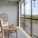 a balcony with table and seating